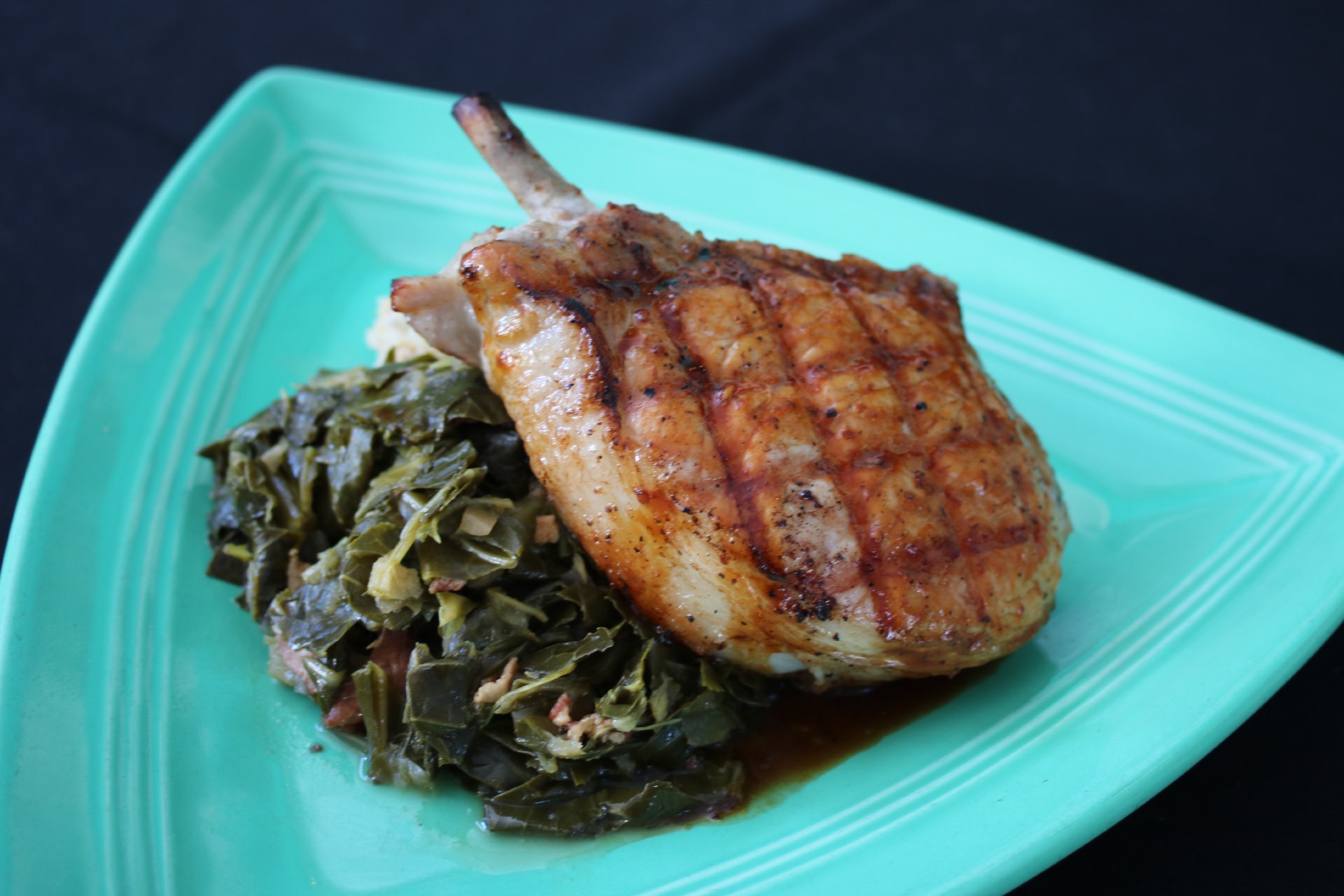 pork chop with house grits and ginger greens